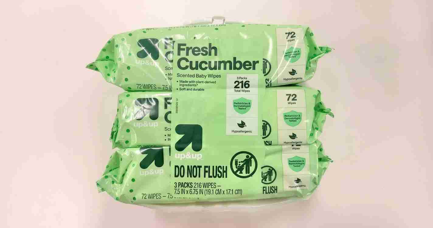 Green packaging of Fresh Cucumber baby wipes, three packs stacked, with a 'DO NOT FLUSH' label on light background.