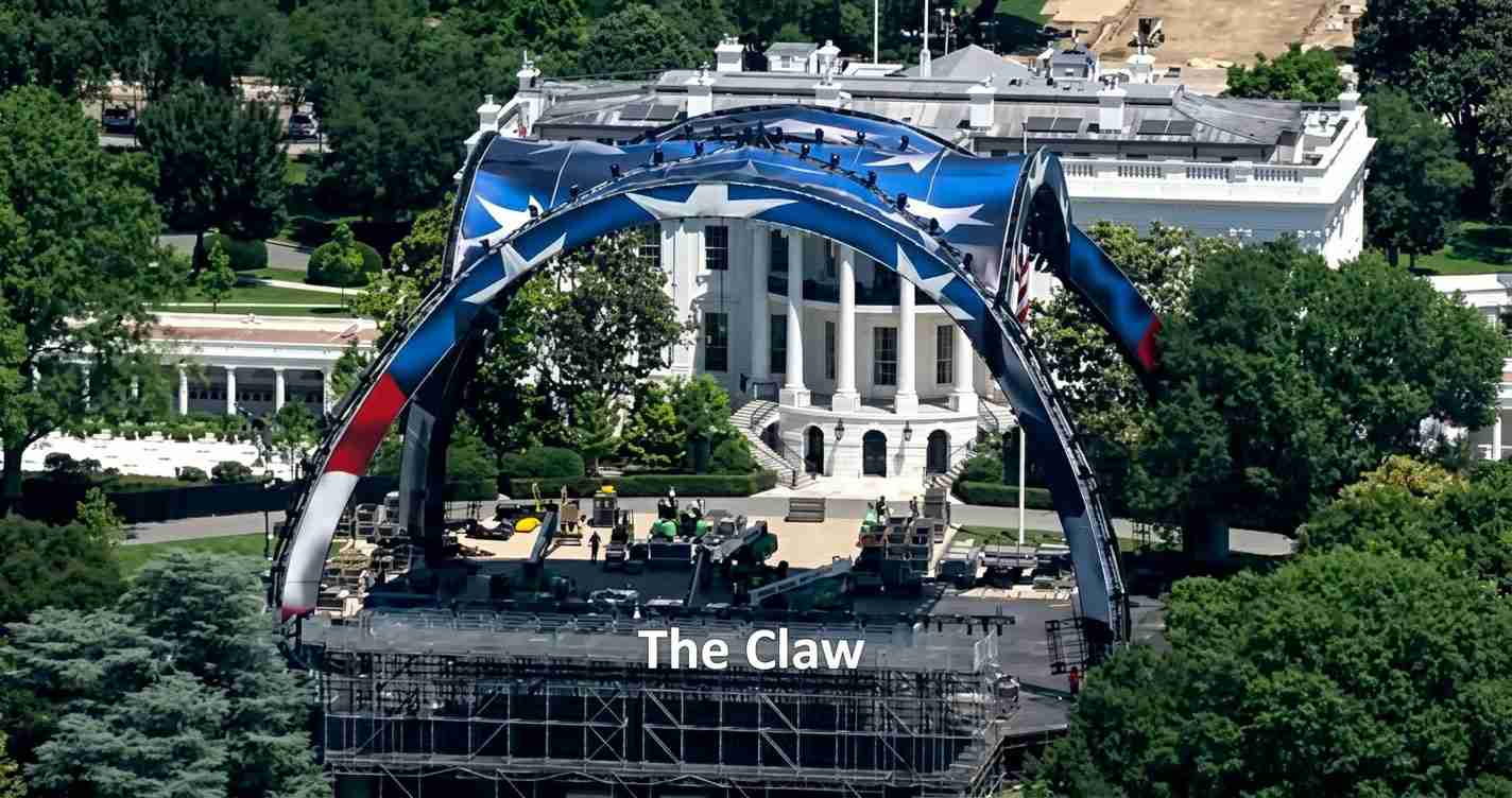 Outdoor stage setup in front of a white government building, with a large blue curved arch labeled 'The Claw' over the stage area.