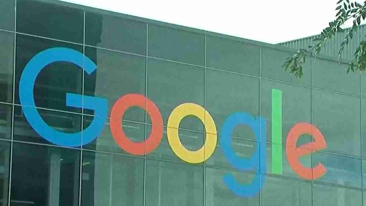 Google logo displayed on the glass exterior of a modern office building, with colorful letters in blue, red, yellow, blue, green, and red across the facade